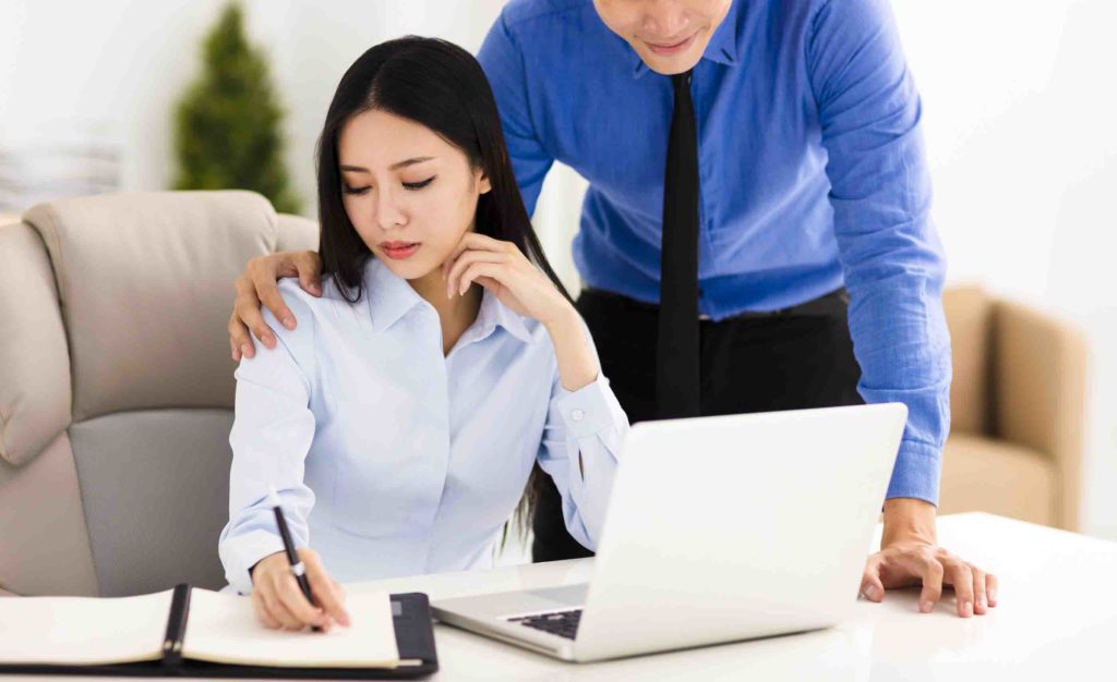 young Business man harassing colleague in office